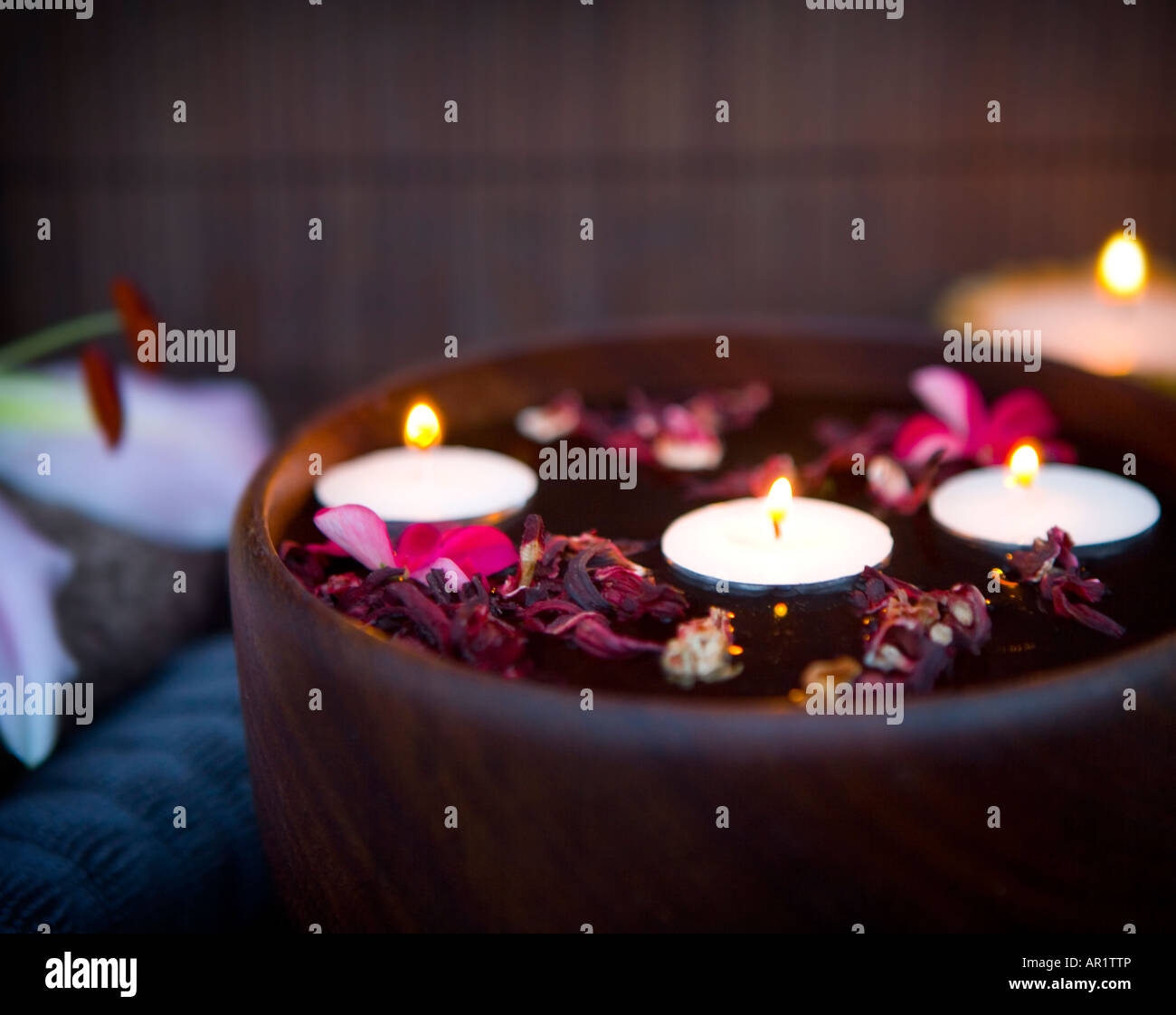 Spa setting with floating candles and folded towels Stock Photo