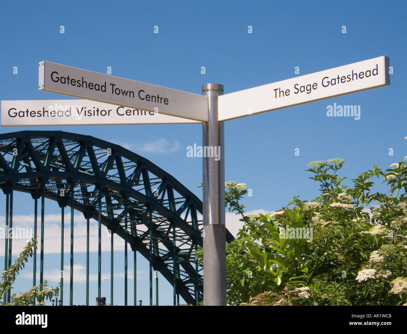 Signpost with Tyne Bridge Newcastle on Tyne England Stock Photo