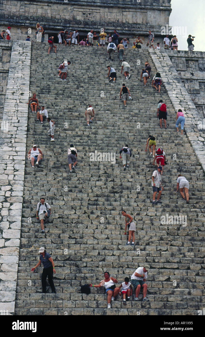 Tourists Climbing The Steep Stairs Of El Castillo Pyramid At Chichen ...