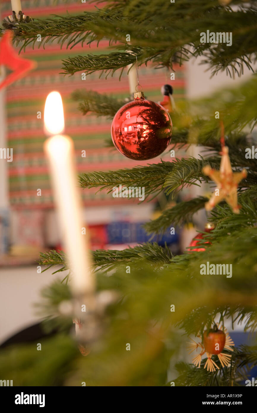 Ornaments and a candle on a real Christmas tree in Germany Stock Photo
