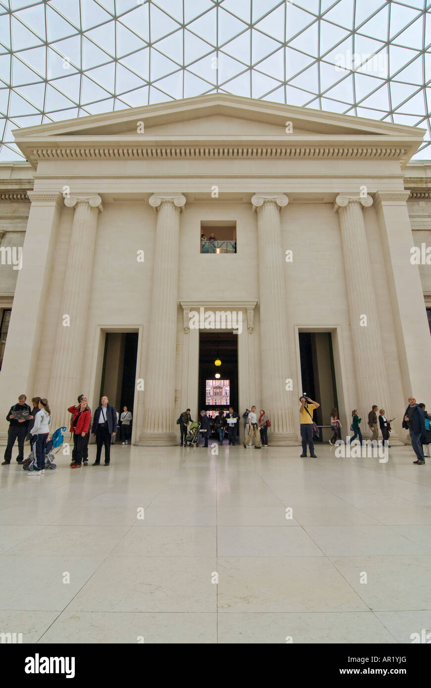 Vertical wide angle of tourists ambling around the South Portico inside the Queen Elizabeth II Great Court in the British Museum Stock Photo