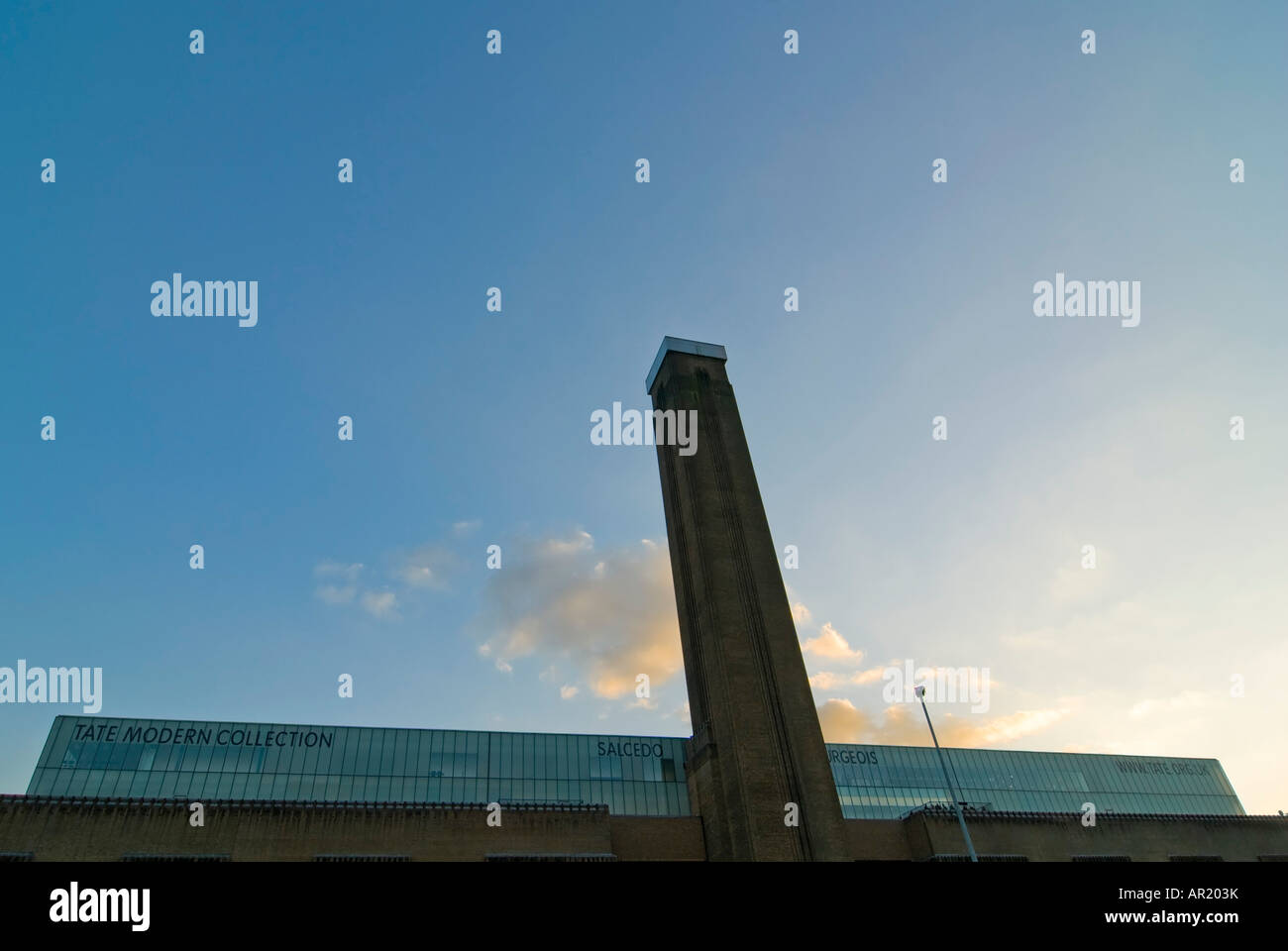Horizontal close up of the distinctive chimney of the Tate Modern museum on a bright sunny evening. Stock Photo