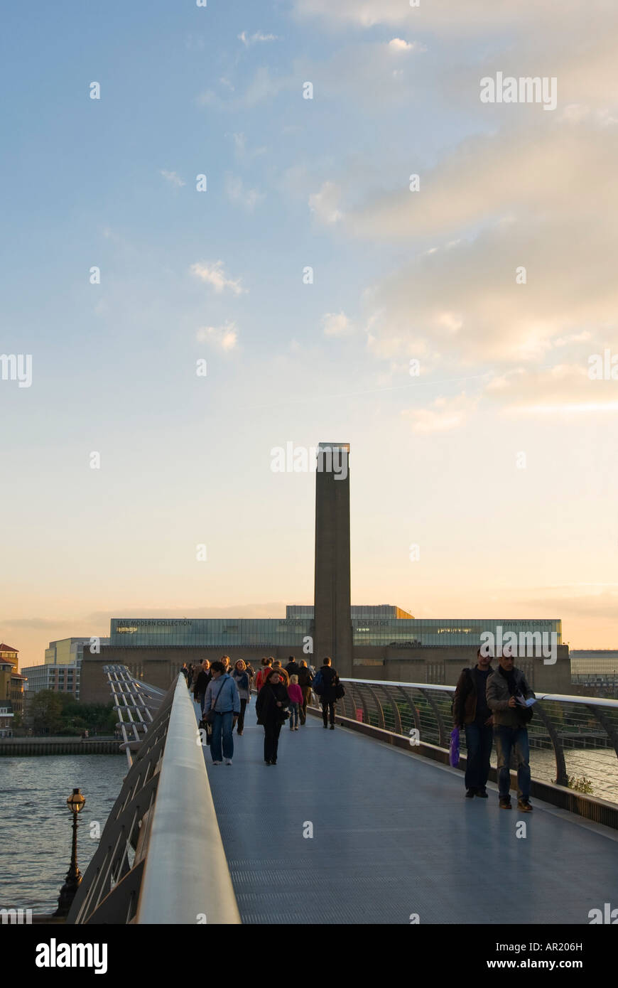 Vertical wide angle of the Tate Modern museum and the Millennium Bridge crossing the river Thames at sunset. Stock Photo