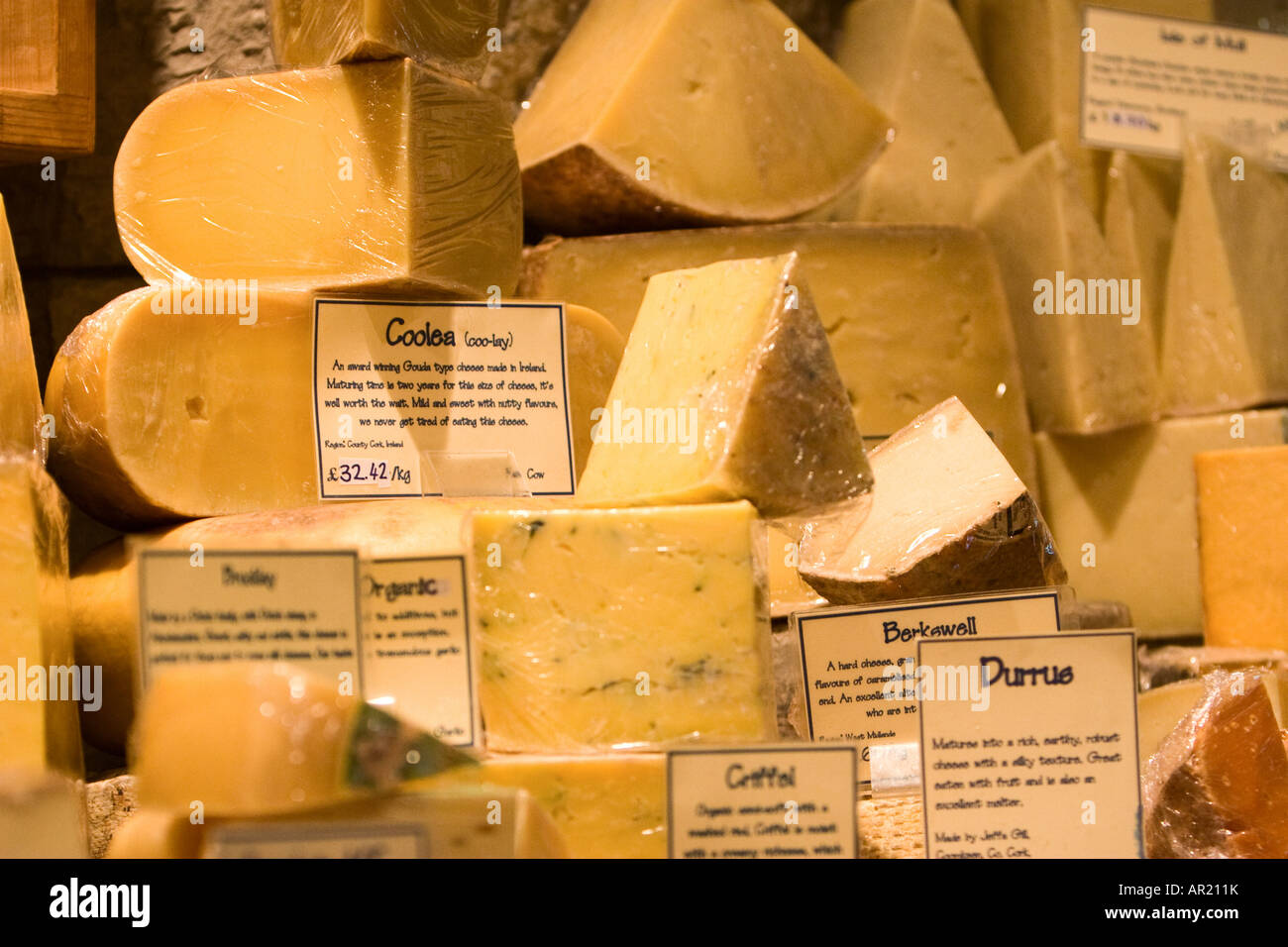 A stack of many different cheeses inside of a cheese shop in Edinburgh