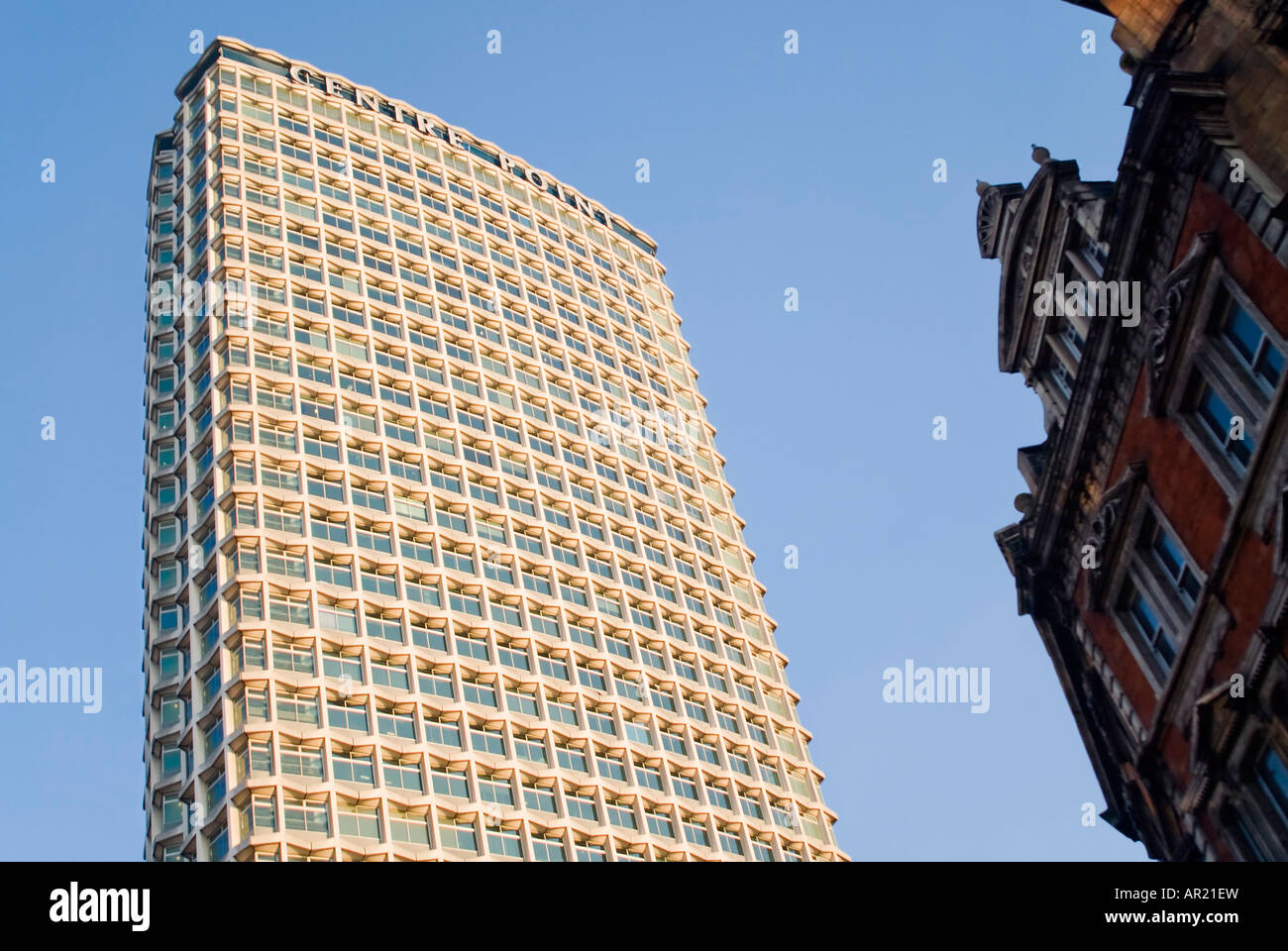 Vertical view of Centre Point - the 1960's concrete and glass office building on Tottenham Court Road against bright blue sky Stock Photo