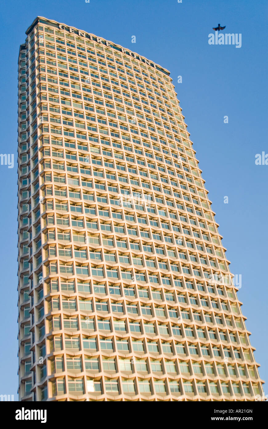 Horizontal view of Centre Point - the 1960's concrete and glass office building on Tottenham Court Road against bright blue sky Stock Photo