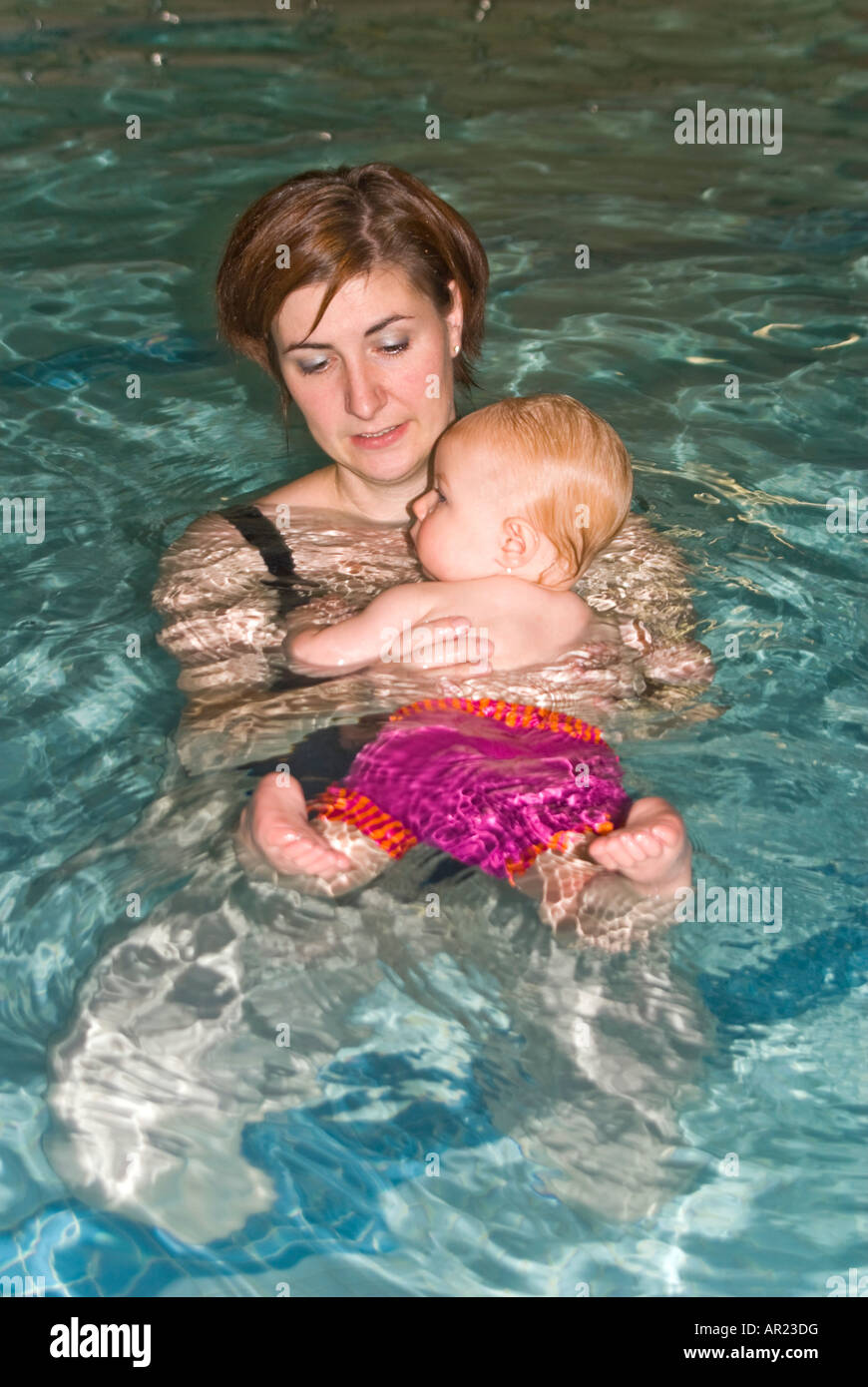 Vertical close up of a young Caucasian mother and baby daughter in a