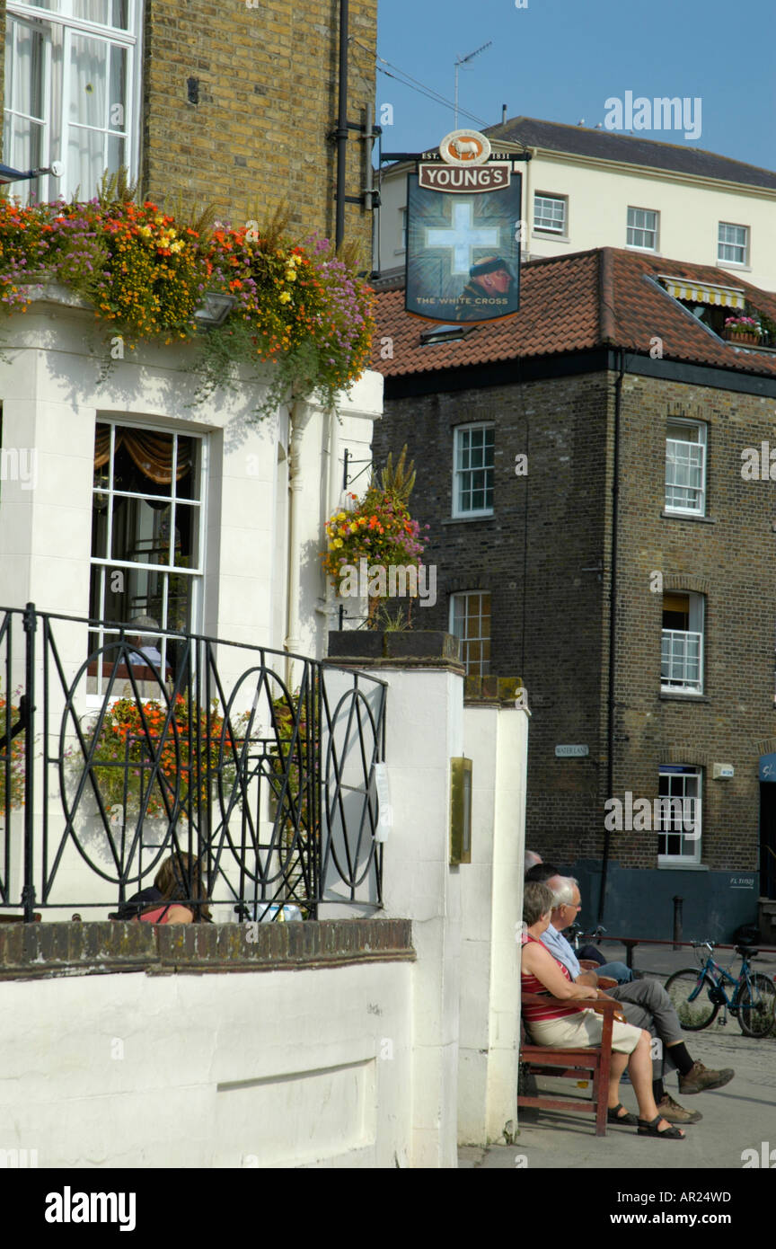 Two middle aged people sitting outside the White Cross pub in Richmond
