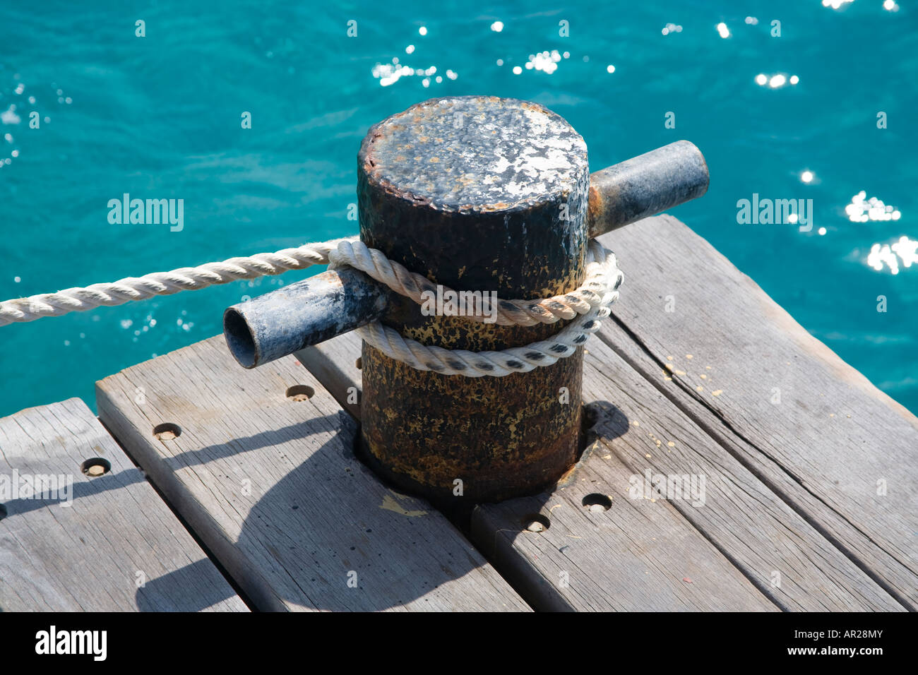 Mooring bollard on a jetty with rope attached Stock Photo Alamy