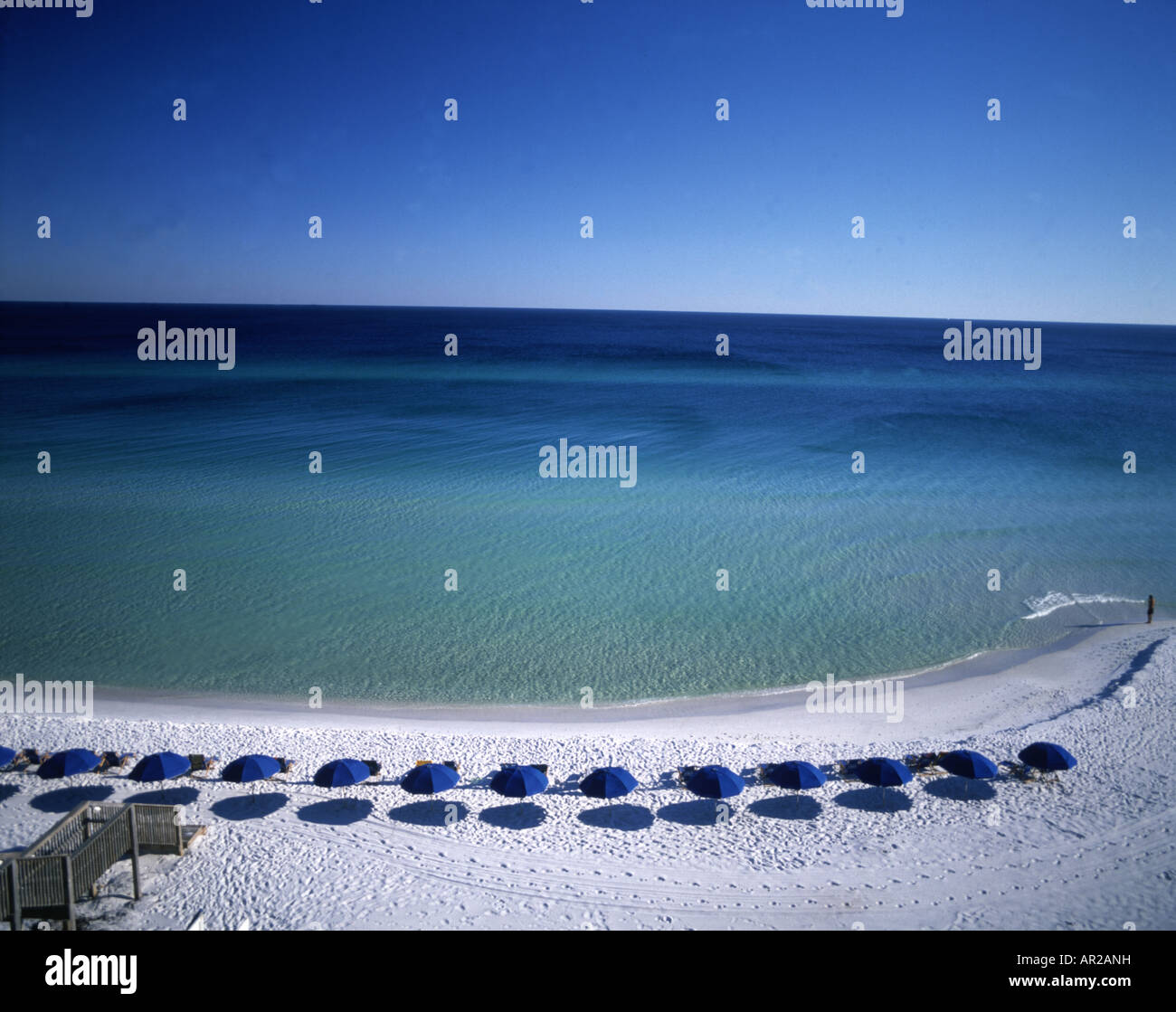 beach on Gulf of Mexico with  blue umbrellas Stock Photo