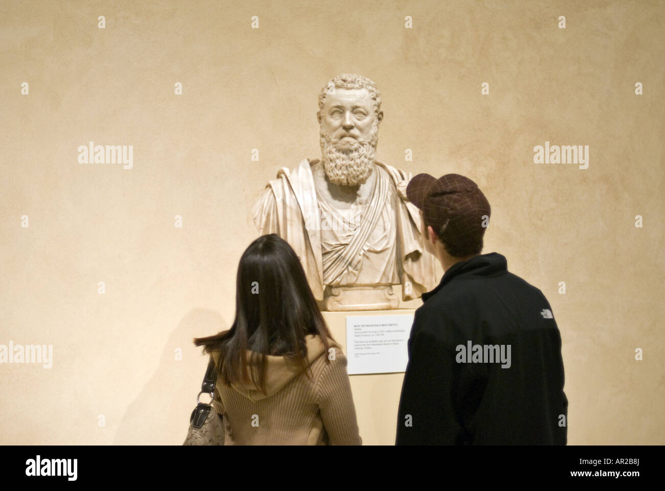 Young Couple Admiring a Marble Bust of Francesco Bocchetta at the Metropolitan Museum of Art in New York City Stock Photo