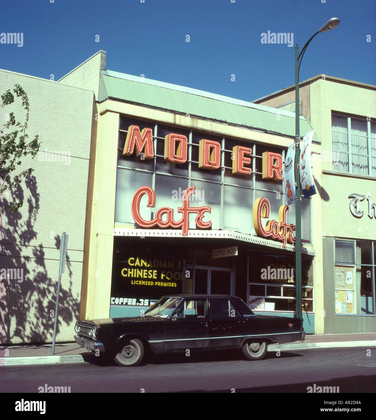 Exterior view of the Modern Cafe 1950s facade and 1970s car parked outside in a street in the town of Nanaimo British Columbia Canada  KATHY DEWITT Stock Photo