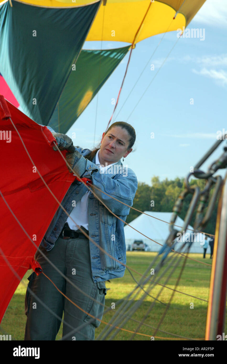 female ground crew holding the balloon open so the hot air can inflate the balloon Balloon Reg No. G-CCKY Stock Photo