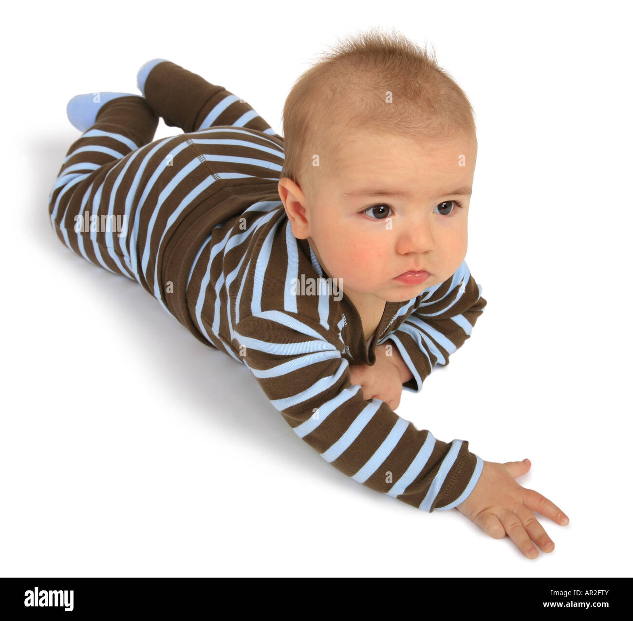 baby in a romper suit lying on its belly Stock Photo Alamy