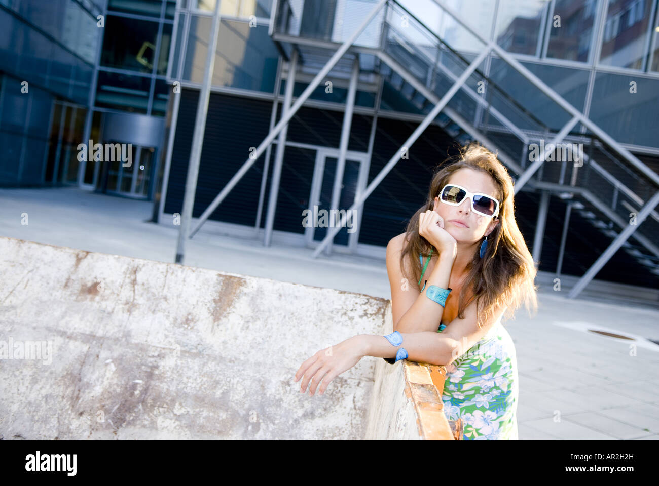 young woman with sunglasses resting head on hand, Austria Stock Photo