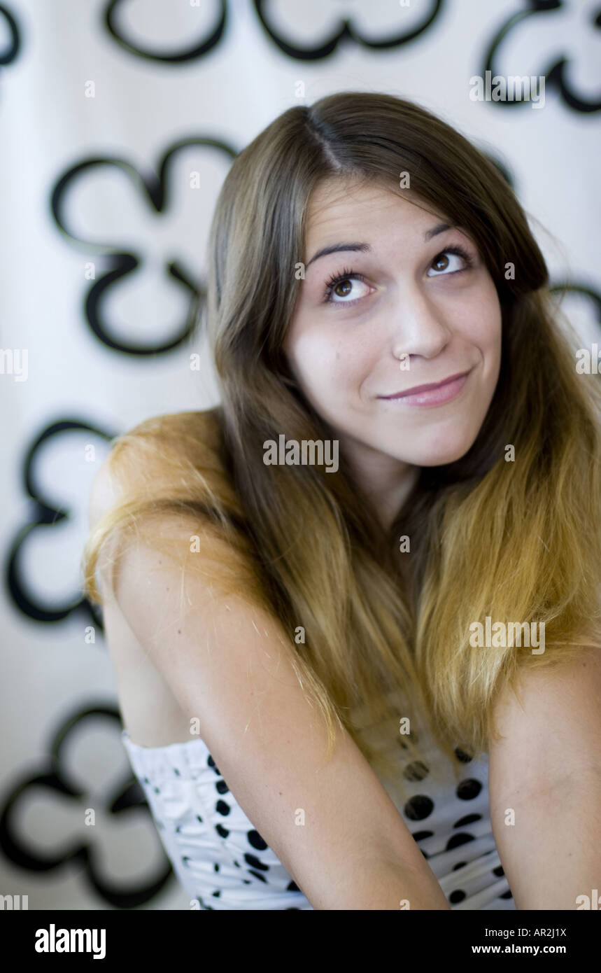 young woman shrugging and looking apologetically Stock Photo