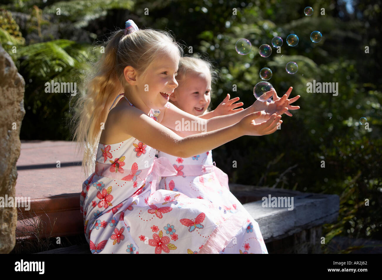 Young girls playing with bubbles Model release 401 Stock Photo - Alamy