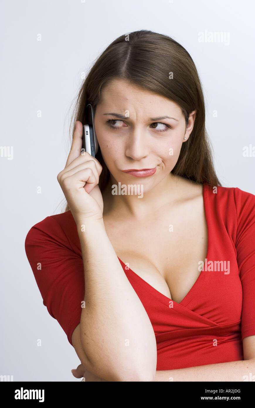 grimly young woman with cellular Stock Photo