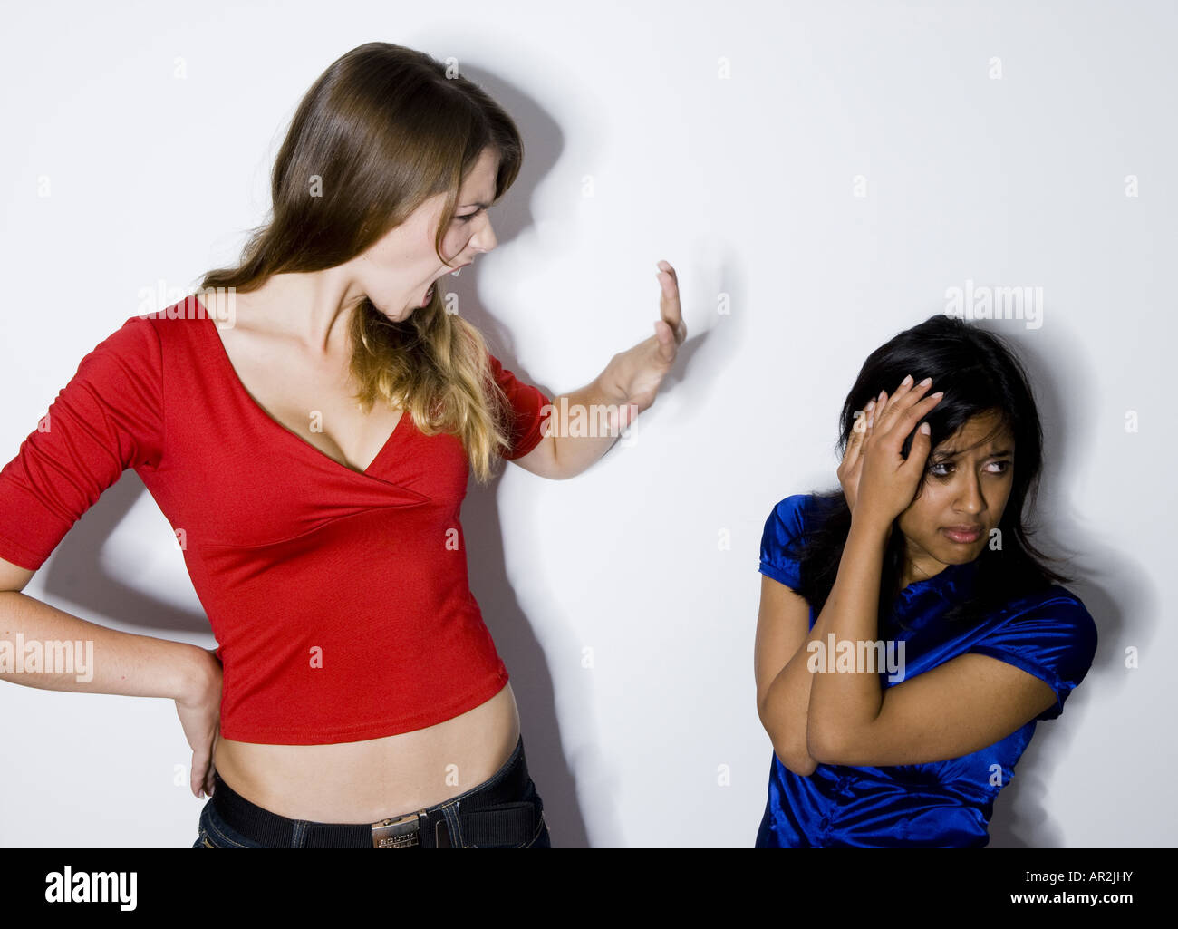 two young women, one aggressiv, the other fearful Stock Photo