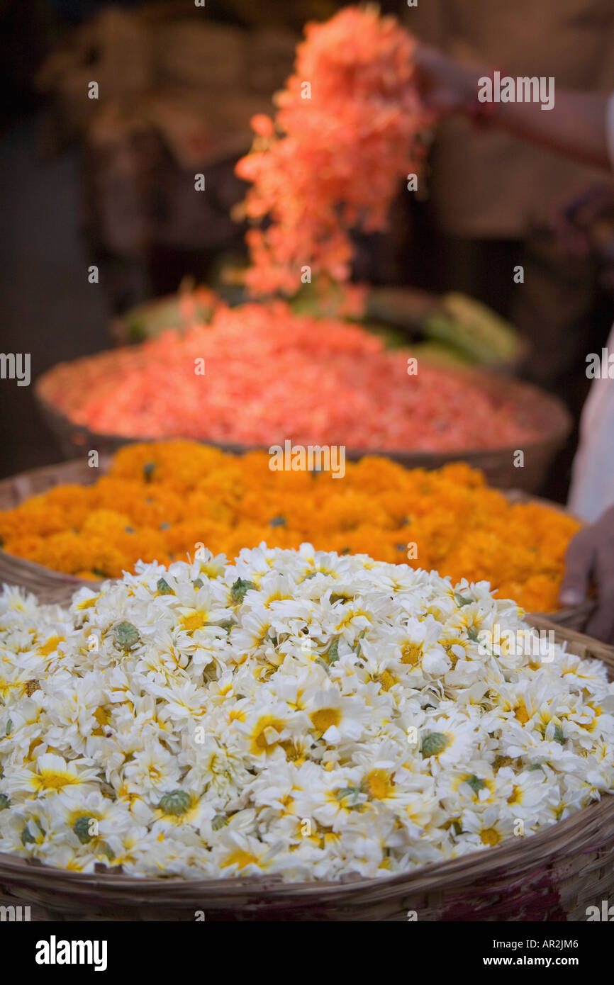 Large baskets of flowers at market Mumbai India Stock Photo