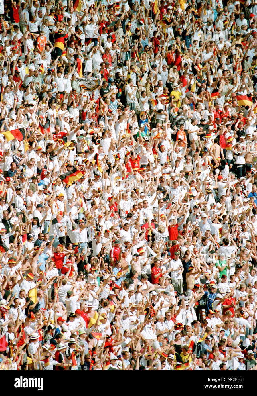 Crowd in sports stadium with arms in air Stock Photo
