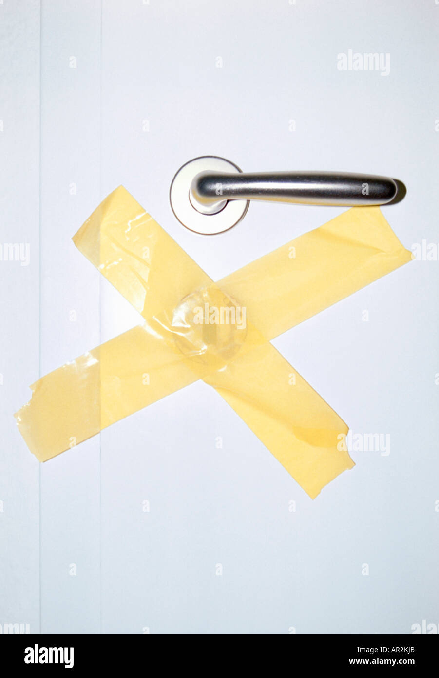Door with lock covered by adhesive tape Stock Photo