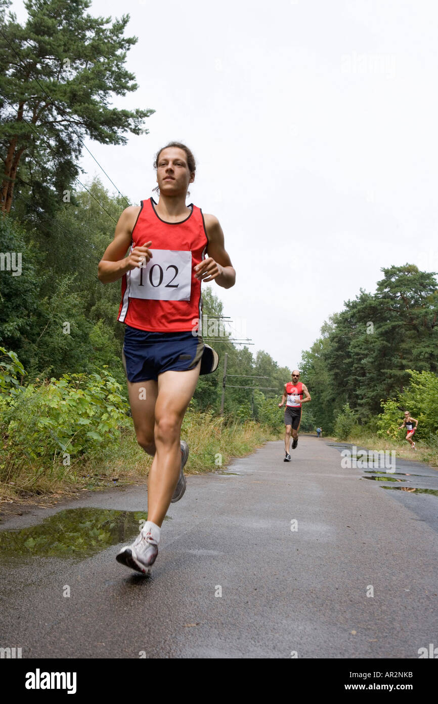 Man in red top running hi-res stock photography and images - Alamy