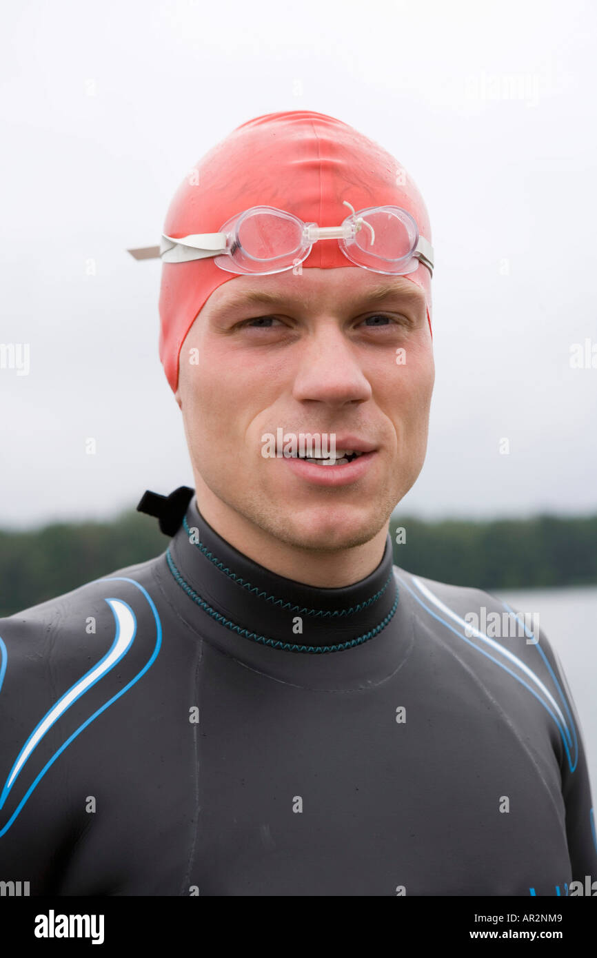 Portrait of triathlete wearing swimming goggles and cap Stock Photo