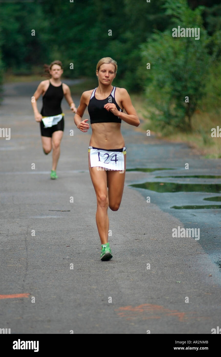 Young woman competing in triathlon Stock Photo Alamy