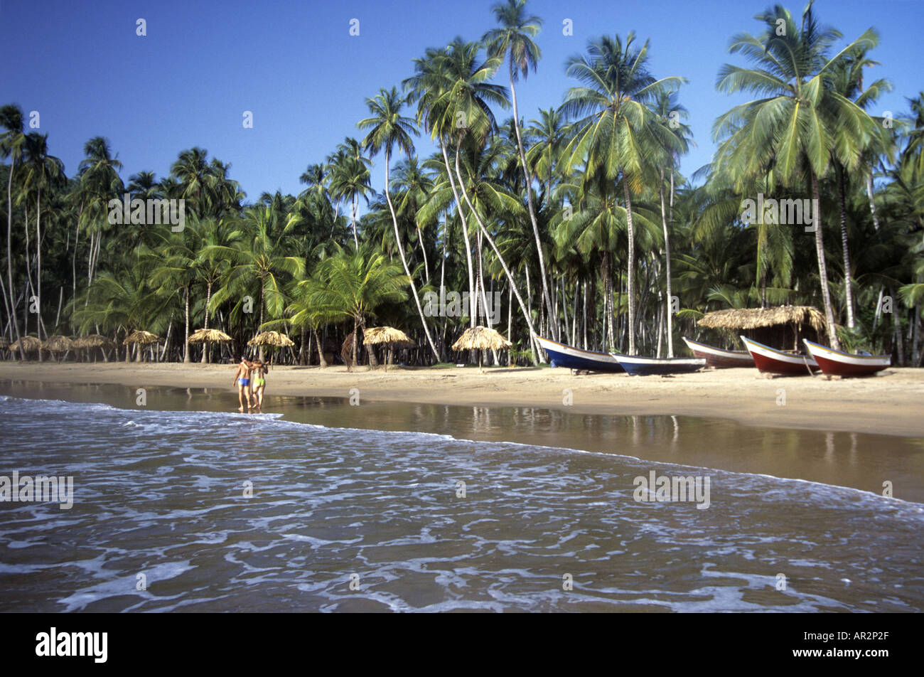 Boats and couple on Playa Medina Beach, Paria Peninsular, Venezuela, South America. Stock Photo