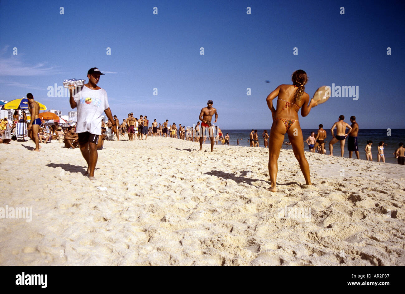 Paddle tennis girl in micro-bikini and drinks vendor, Ipanema Beach, Rio de  Janeiro, Brazil, South America Stock Photo - Alamy