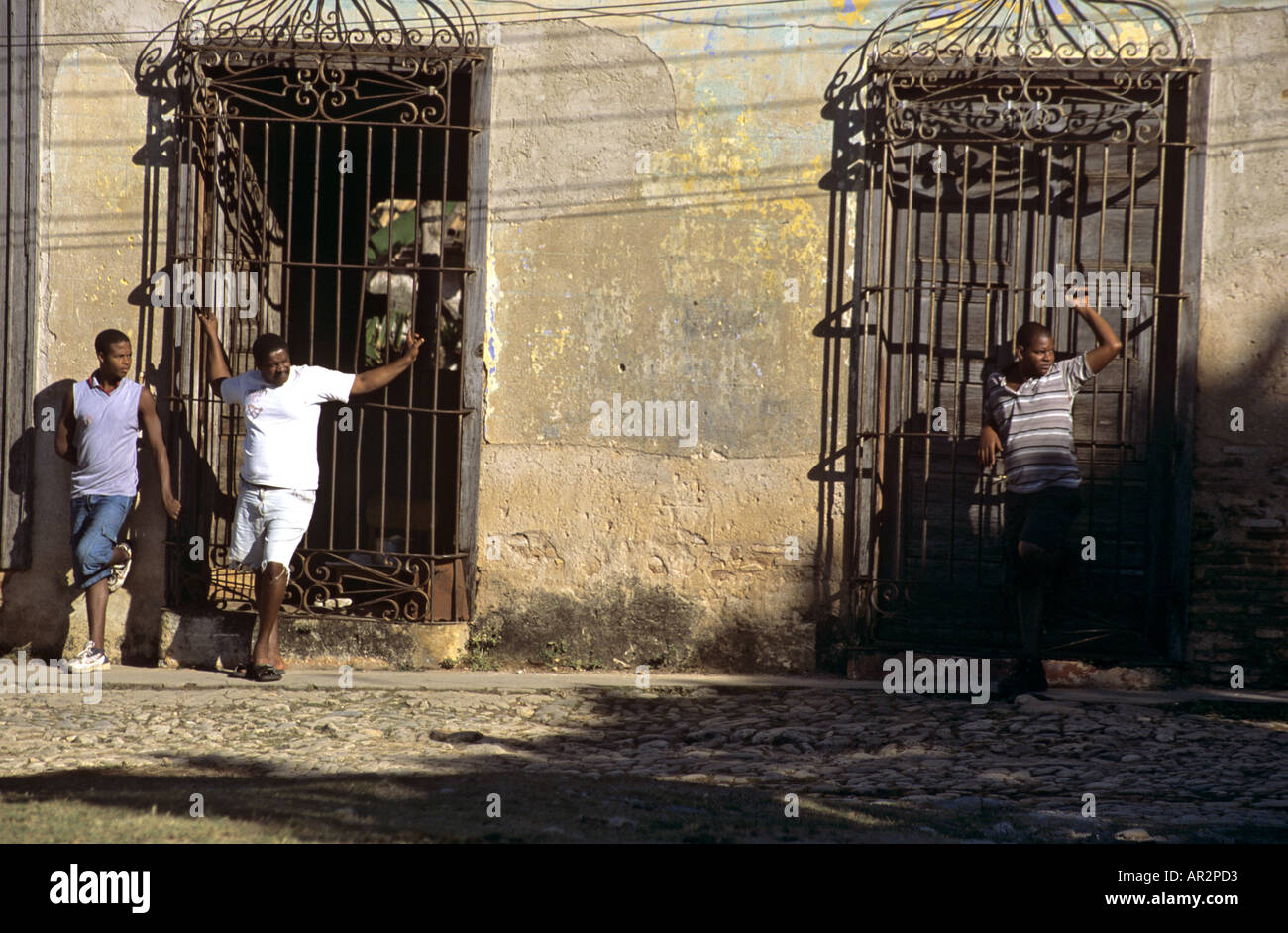 Local men hanging around against door railings and peoplewatching