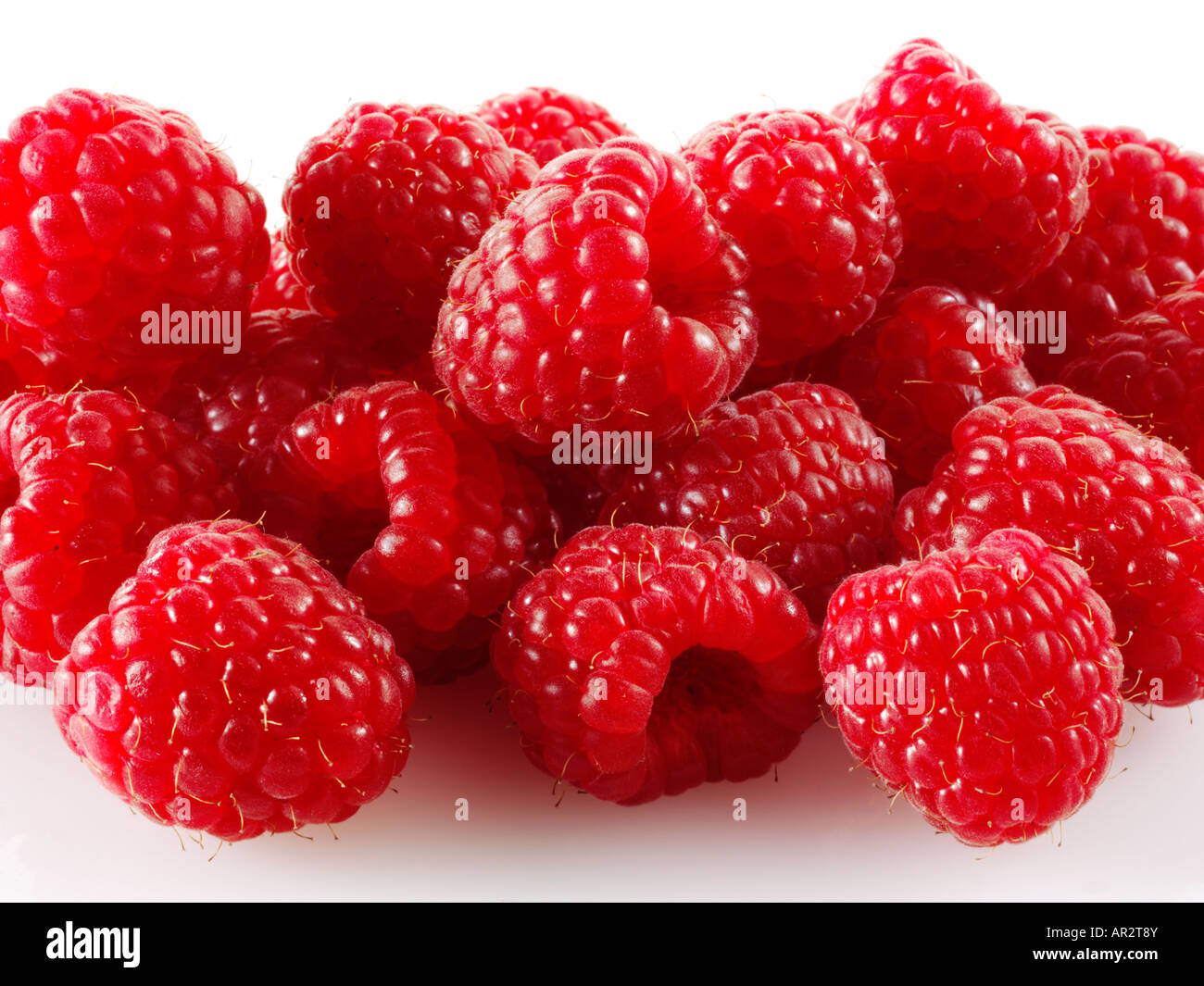 pile of Raspberries on a white background Stock Photo Alamy