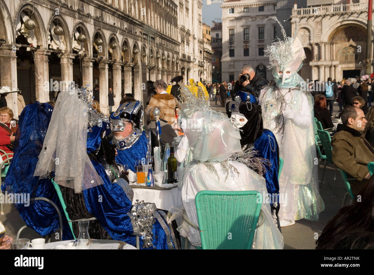 Revellers in mask and costume at the Venice carnival at a cafe in St ...