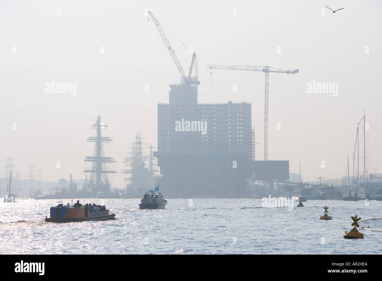 HOLLAND AMSTERDAM THE IJ HARBOUR SILHOUETTE OF SHIPS AND BUILDINGS Stock Photo
