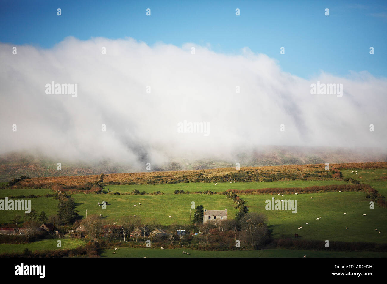 Clouds Creeping Over Mountain and Down Towards Home in Slea Head Dingle Peninsula County Kerry Republic of Ireland Europe Stock Photo