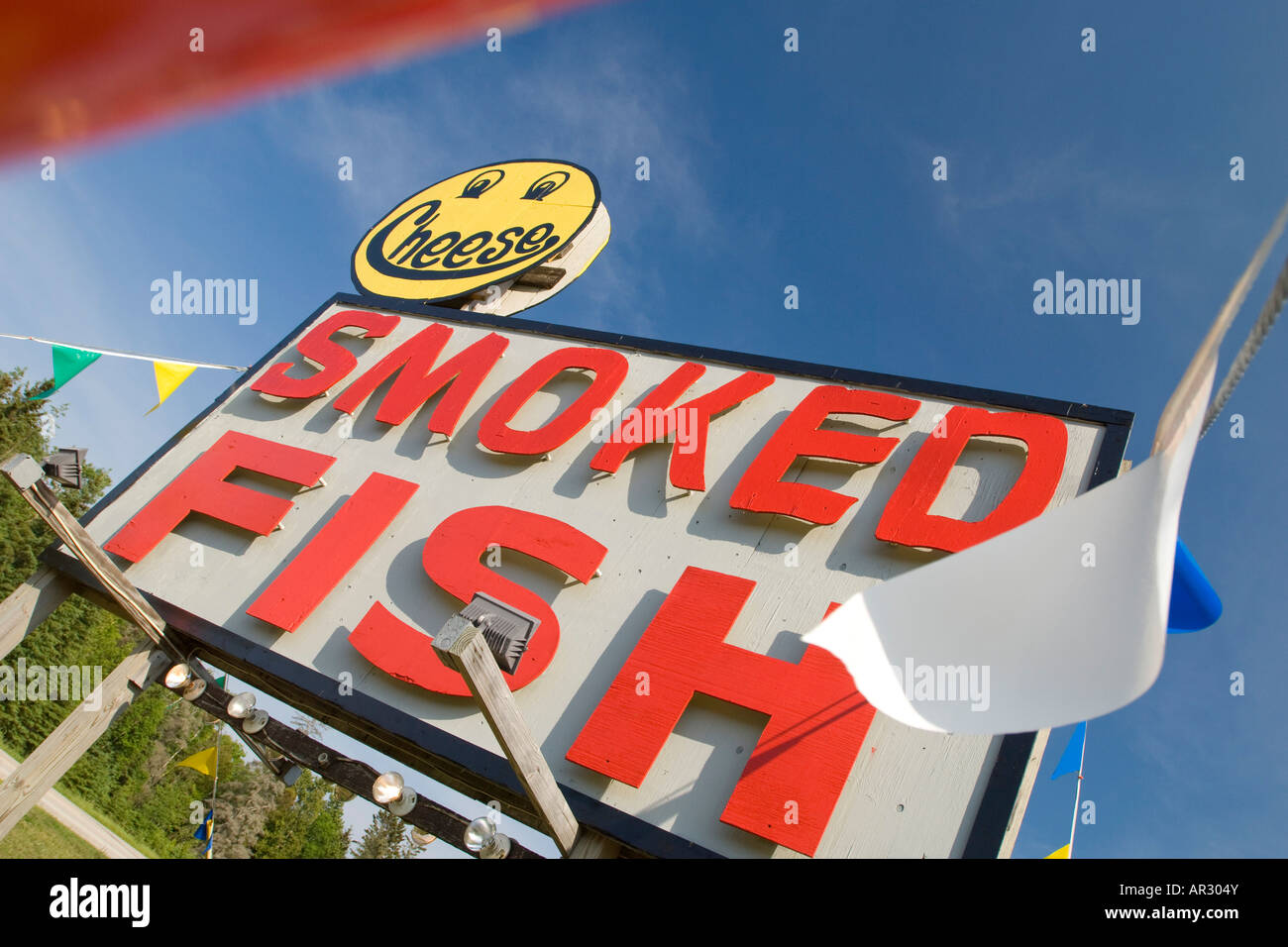 A sign for smoked fish and cheese entices tourists along US 2 in