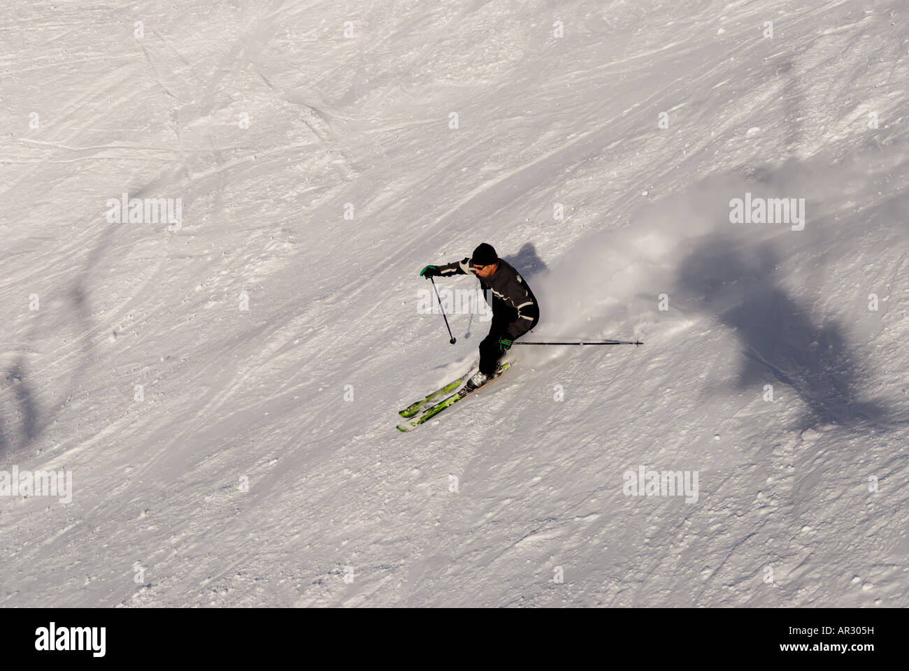 Downhill skiing in the french alps with a chair lift in the shot Stock Photo