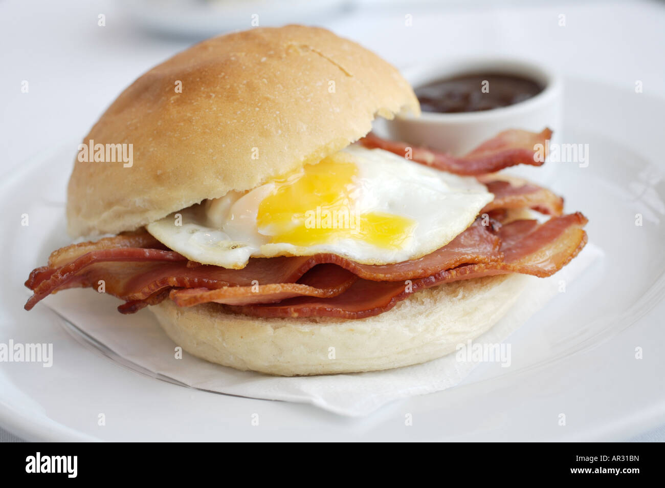 Bacon and fried egg buttie with brown sauce on the side Stock Photo Alamy