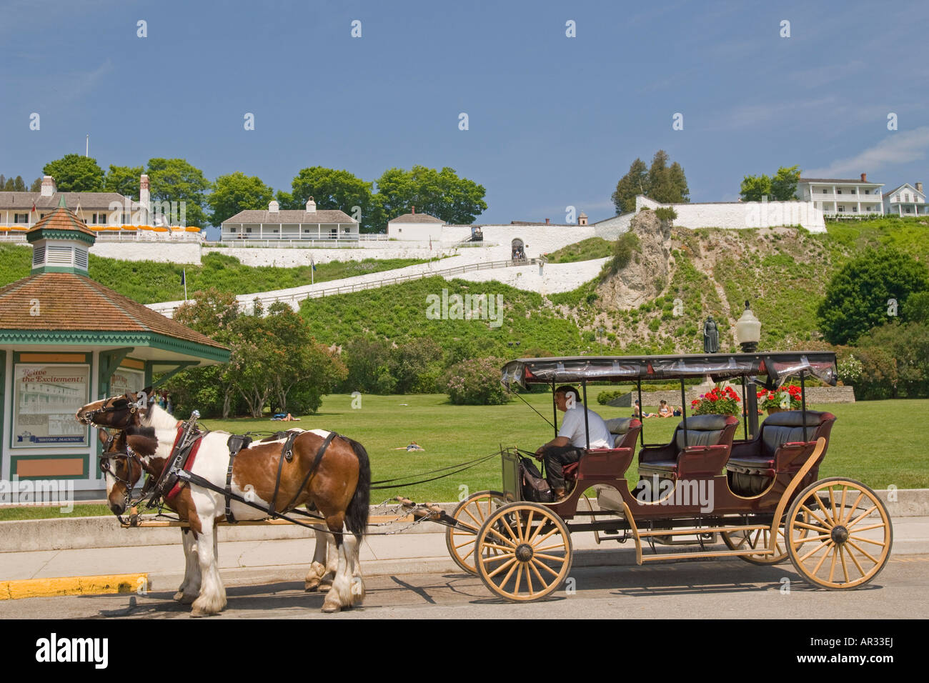 A horse drawn carriage gives tours in front of Fort Mackinac State Park