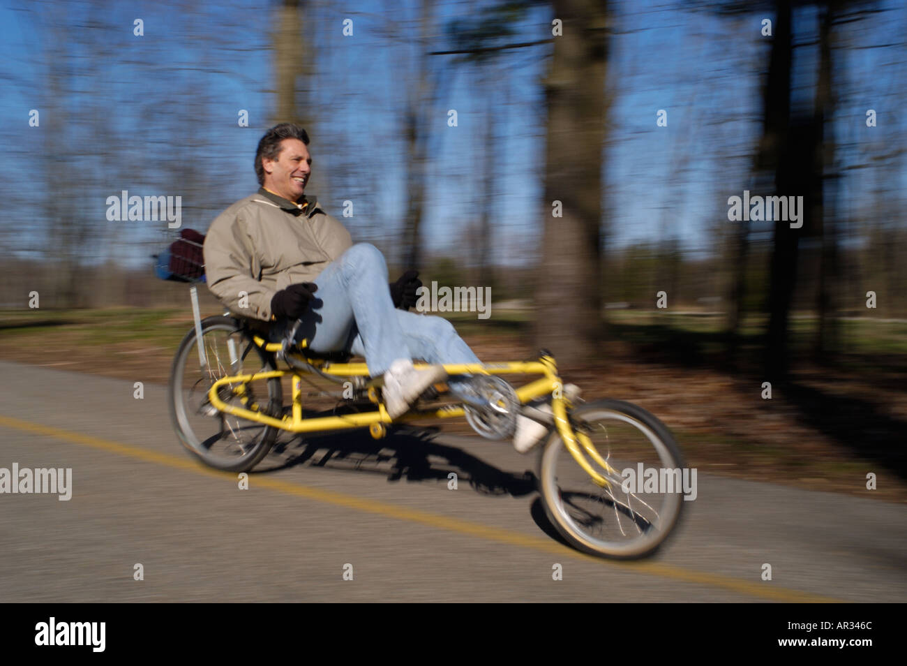 man riding recumbent bicycle down hill Stock Photo
