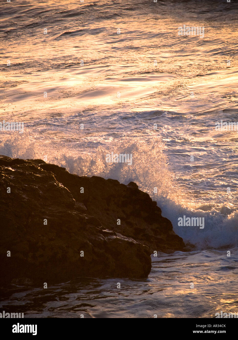 Wave breaking against rocks, Gwithian Stock Photo