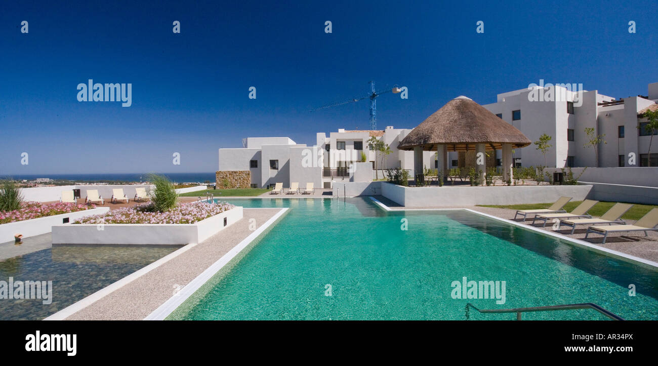 Green swimming pool on summer day with blue sky with modern white ...