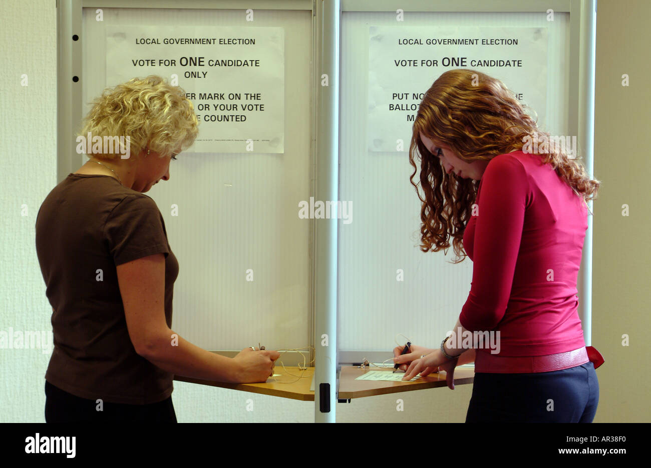 People Vote Women Voting Booth Votes for women Election day Stock Photo