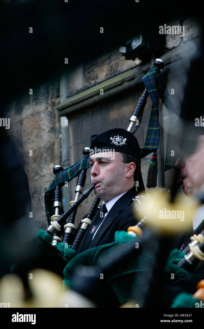 Lone Scottish Piper Edinburgh Scotland framed through bagpipes Stock