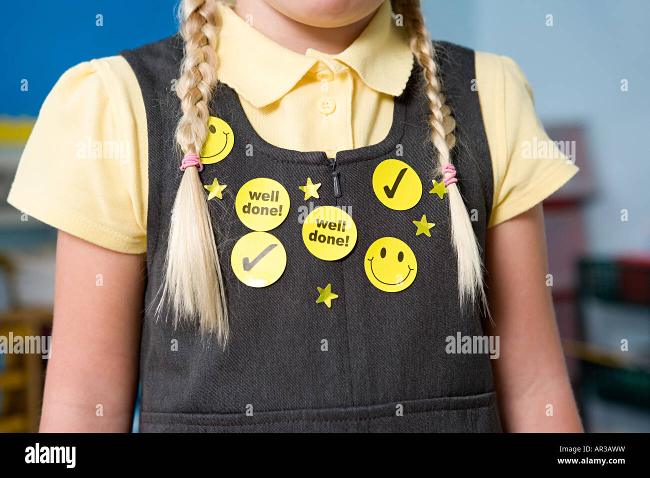 Stickers on a girls pinafore Stock Photo