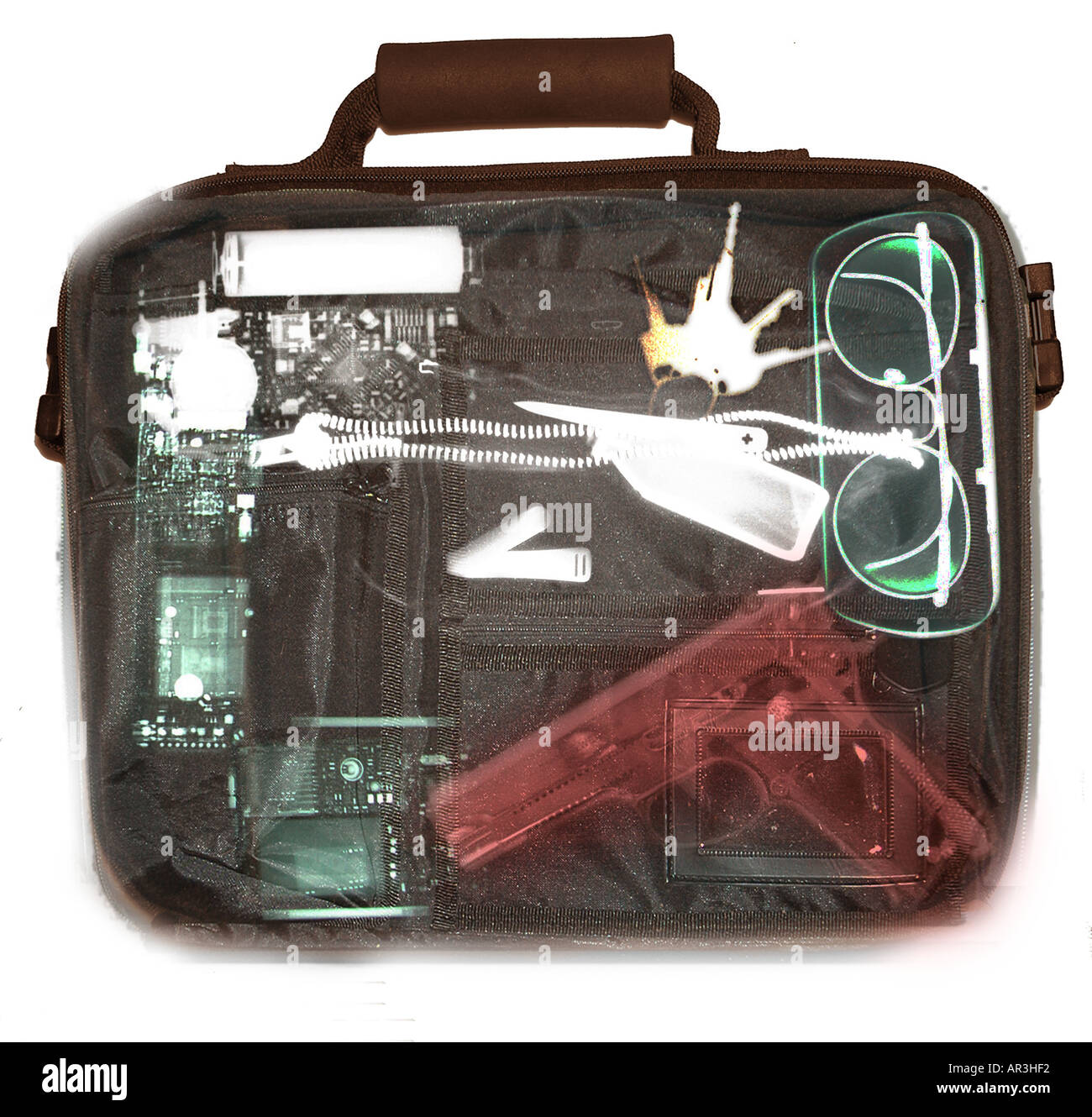 Simulated airport security xray showing a briefcase containing a Smith and  Wesson 9mm handgun Stock Photo - Alamy