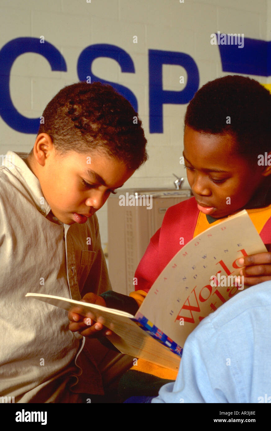 Students age 10 reading in community study program. St Paul Minnesota USA Stock Photo