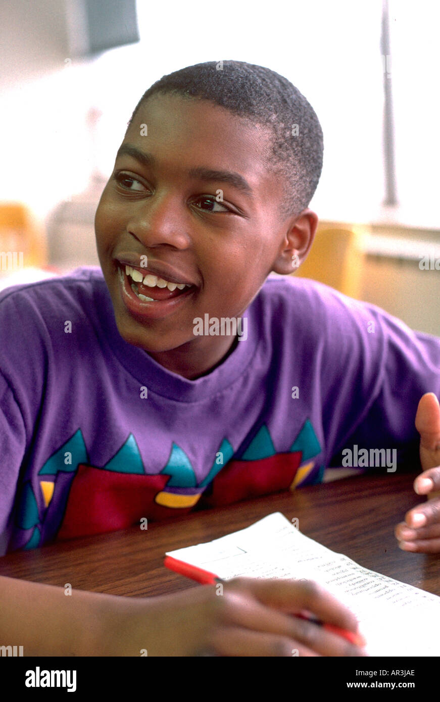 Youth age 12 reading in community after school study program. St Paul Minnesota USA Stock Photo