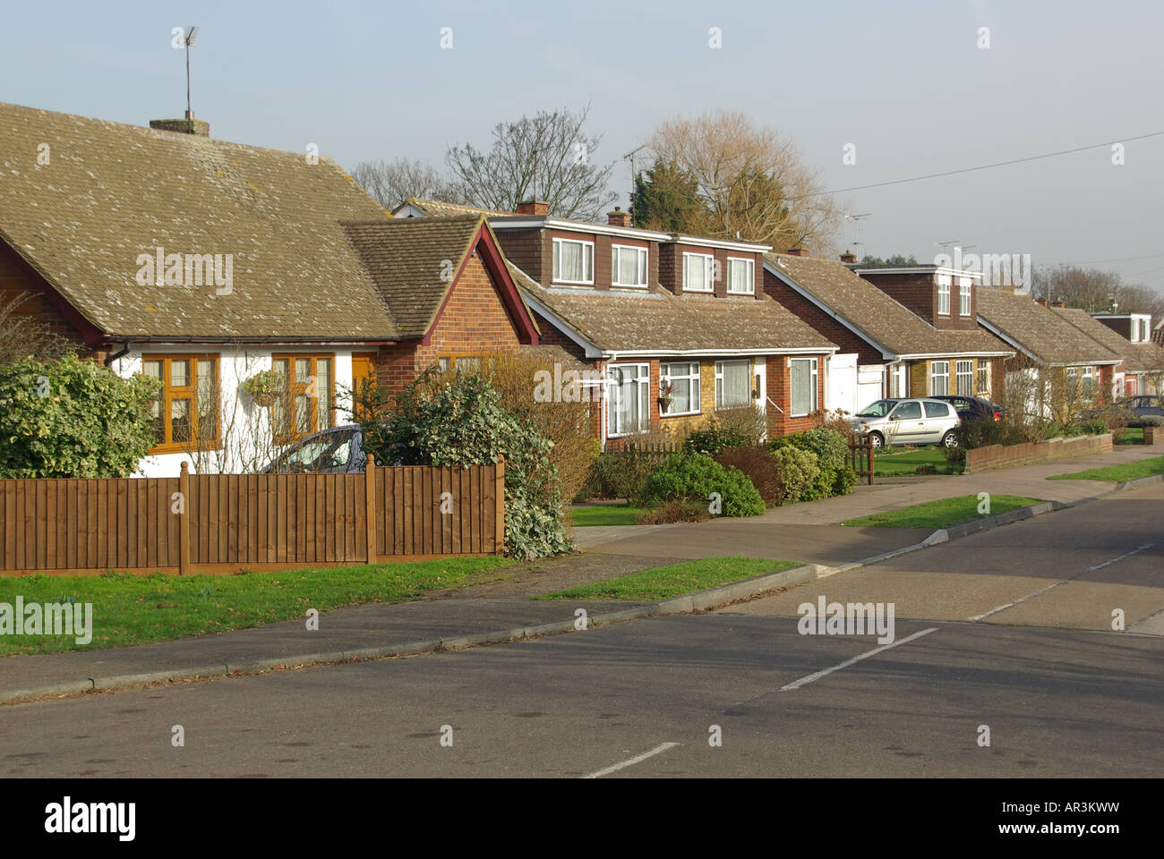 Village residential road detached and semi detached bungalows includes some dormer windows Stock Photo